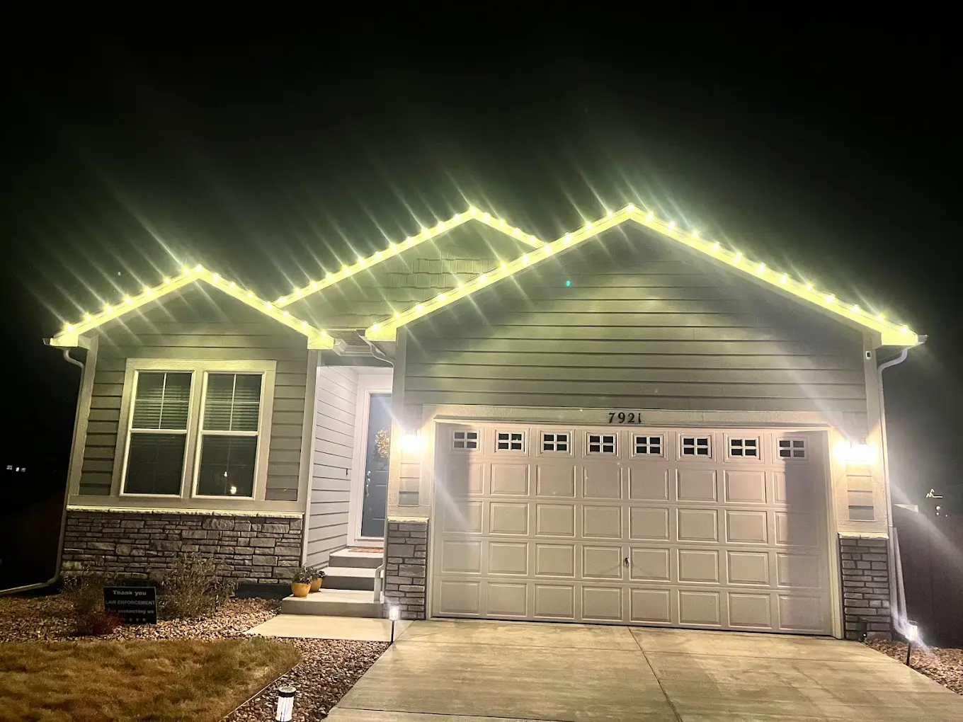 Portfolio example: warm white LED roofline Christmas lights on a single-family home, Front Range install
